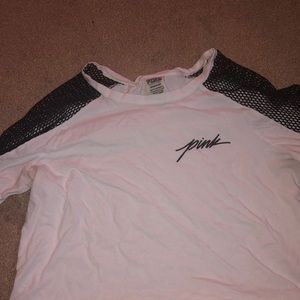 A Pink white crop top with fishnet sleeves
